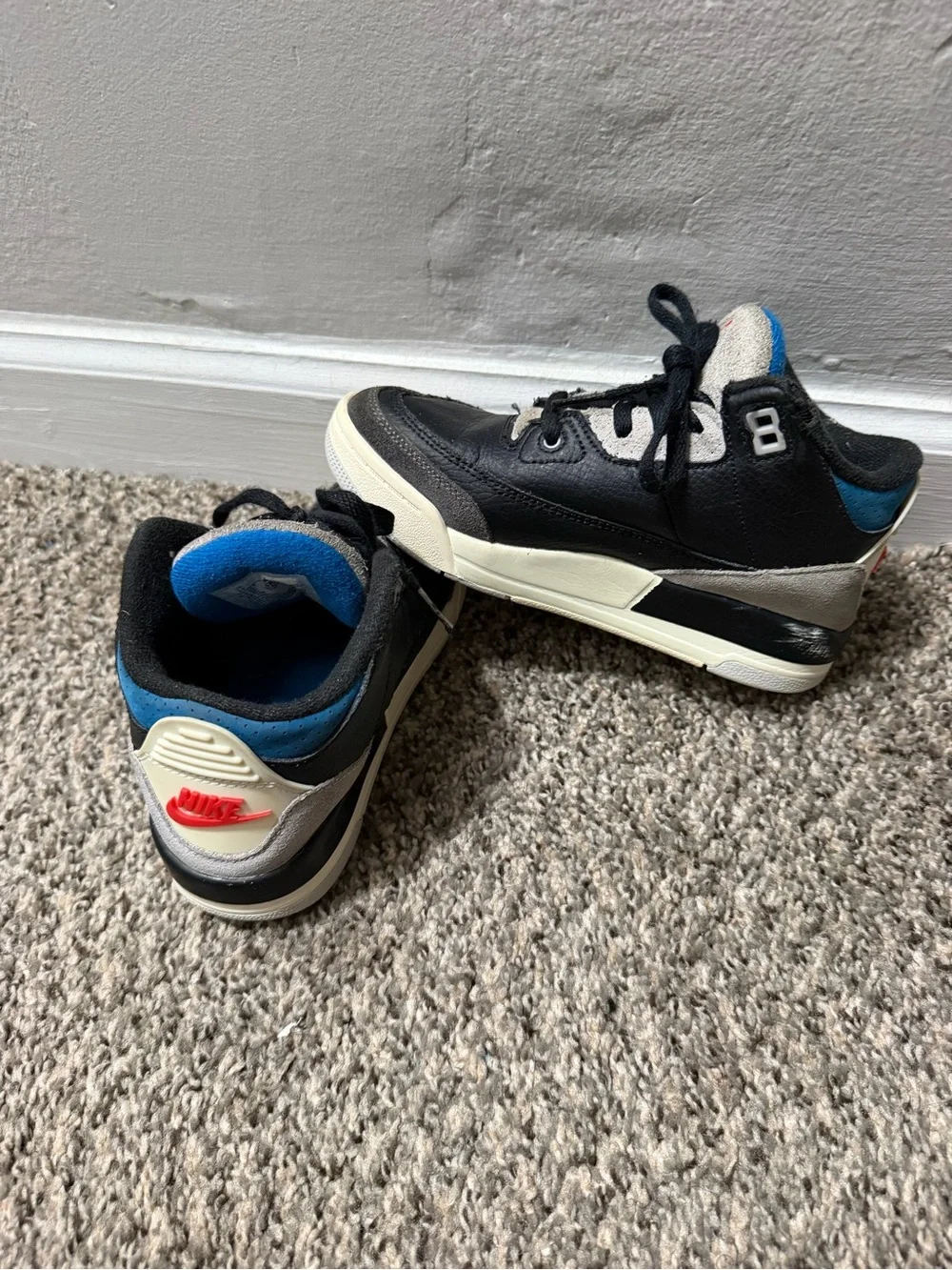 Nike Kids Black and Cream Sneakers with Blue and Red Accents